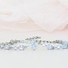 A single strand of diamonds will beautifully complement any wedding dress. Diamonds go with everything, just as lab diamonds go with every color.The CZ marquise will make a perfect finishing touch to your elegant look.DETAILS● Designed and handcrafted by ©JazzyAndGlitzy● This delicate drop and leaf-designed bridal bracelet feature AAA+A grade cubic zirconium.And the finish is with rhodium-plated silver or rose gold.● The bracelet measures 6 inches long + 2 inches extender chain.● Lead, nickel, a Elegant Cubic Zirconia Crystal Bracelet With Diamond Cut, Elegant Cubic Zirconia Bracelet With Diamond Cut, Elegant Diamond Cut Cubic Zirconia Crystal Bracelet, Diamond White Crystal Bracelet With Diamond Cut, Diamond Cut Crystal Bracelet In Diamond White, Delicate Sparkling Cubic Zirconia Jewelry, Elegant Marquise Tennis Bracelet For Anniversary, Marquise Cubic Zirconia Bracelet With Diamond Accents, Marquise Cubic Zirconia Bracelets With Diamond Accents