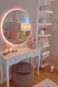 a white vanity with a round mirror and stool in front of it on top of a hard wood floor