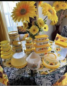 sunflowers and dishes are sitting on a table