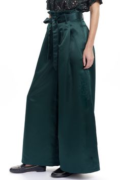 The Tony pant is a wide leg trouser with a paperbag style waist and a tie belt. There are welt back pockets and 2 side front pockets and belt loops. Shown in our exclusive Low shine satin. Content: 100% Poly Color: Pine Fits: Fitted at the waist then Relaxed Sizes: XS-L What we Love: Modern and dramatic trouser Limited Edition Made in Lovely Downtown Los Angeles Model is 5'9" size 2 and is wearing a size S Emerald Pants, Witchy Wardrobe, Soft Dramatic, Lady Loki, Gaucho Pants, High Waist Wide Leg Pants, Fashion Tops Blouse, Silk Trousers, Office Attire