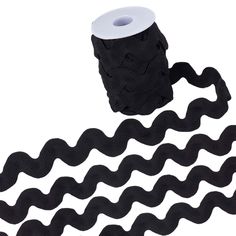 a roll of black rope with white spools on top and two rolls in the middle