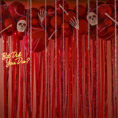 red balloons with chains hanging from them and skulls on the wall behind them that say, best day you're