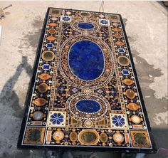 an intricately designed table is shown on the ground