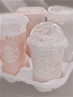 starbucks iced coffees in plastic cups with pink frosting on the top and bottom