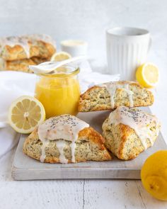 lemon poppy seed scones on a cutting board with honey and lemons around them