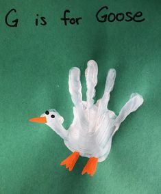 a hand made out of paper with the words g is for goose on it