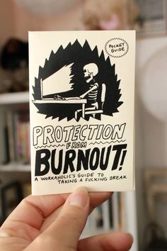 a person holding up a sticker that says, protection is not a burnout