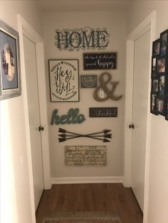 the hallway is decorated with family and friends signs, photos, and other decorative items