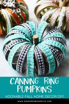 some decorative pumpkins that are sitting on a table with ribbon around them and the words canning ring pumpkins