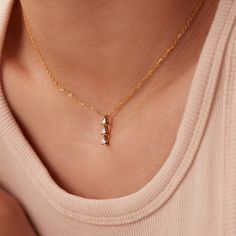 Discover the exquisite beauty of our Dainty Stainless Steel Zircon Pendant Necklace. This stunning piece features a mesmerizing zircon pendant that is meticulously inlaid in high-quality stainless steel. With its 18K PVD gold plating, this necklace exudes a luxurious and elegant appeal. The link chain adds a touch of sophistication, while the adjustable length of 15.5-17.5 inches ensures a perfect fit for every neckline. Elevate your style and make a statement with this captivating necklace, perfect for any occasion or as a thoughtful gift for someone special. Crystal Drop Necklace With Sparkling Stones For Gift, Elegant Crystal Necklace For Her, Cubic Zirconia Charm Necklaces For Weddings, Fine Jewelry Wedding Charm Necklace With Clavicle Chain, Dainty Diamond Rhinestone Necklace As Gift, Cubic Zirconia Charm Necklace For Weddings, Gift Drop Necklace With Sparkling Cubic Zirconia, Dazzling Cubic Zirconia Crystal Necklace As Gift, Diamond White Cubic Zirconia Crystal Necklace As Gift