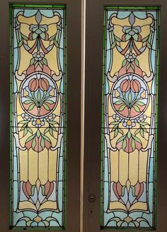 two stained glass doors with decorative designs on them