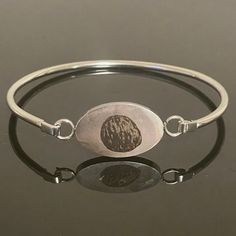 Custom bangle bracelet engraved with your very own embryo!  Stainless steel charm on bangle bracelet. Hypoallergenic, tarnish and rust-proof. Select gift certificate to pre-order this item if you would like to send as a gift but are missing the photo or other details. You will receive a gift certificate via email that can be redeemed by you or another at a later date! Free shipping now or later! Commemorate a transfer or celebrate a new pregnancy with a personalized piece of jewelry showcasing y Etched Metal Bangle As Gift, Minimalist Oval Bangle As A Gift, Minimalist Oval Bangle As Gift, Minimalist Oval Bangle Gift, Silver Engraved Bracelet For Memorials, Engraved Silver Bracelet For Memorial, Silver Engraved Bracelet For Memorial, Oval Engraved Bracelets For Gifts, Memorial Engraved Silver Bracelets