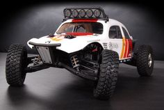 an off - road vehicle with four wheels and lights on it's body is shown