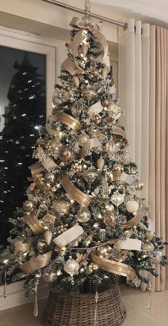 a christmas tree with gold and silver decorations