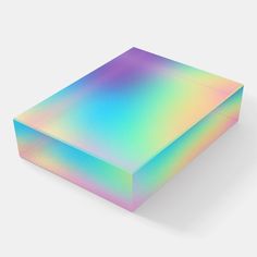 a box that is sitting on top of a white surface with a multicolored pattern