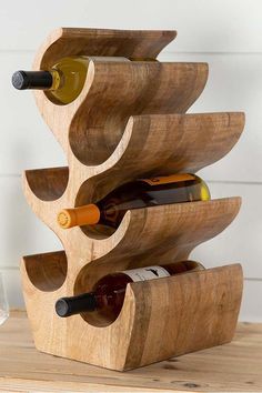 a wooden wine rack with bottles in it