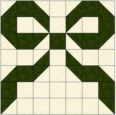 a green and white quilt block with an arrow design on it's center piece