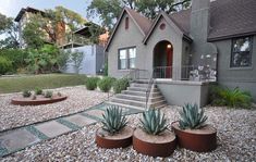 a house that has some plants in front of it