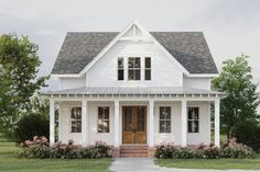 a white house with a porch and two windows