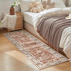 a bedroom with a large rug on the floor next to a bed and nightstands