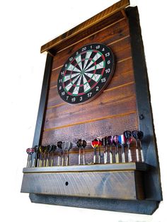 a dart board mounted to the side of a wall with darts in front of it