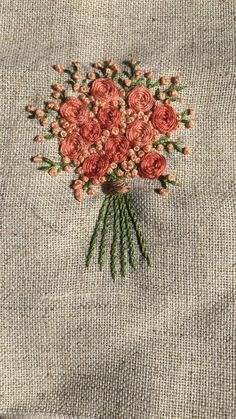 a bunch of flowers that are on top of a piece of cloth and some thread