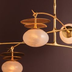 a chandelier with three globes hanging from it's arms and two lights on each side