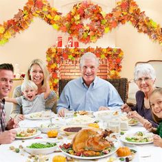 a group of people sitting around a table with plates of food in front of them