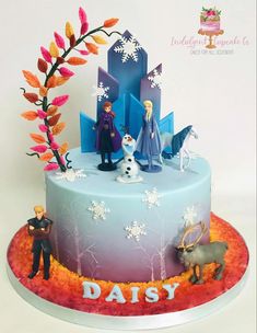 a frozen princess cake with figures on top