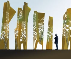 a person standing in front of some tall yellow poles with trees on them and the sky above