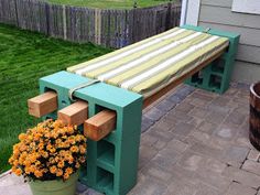 a wooden bench sitting next to a flower pot