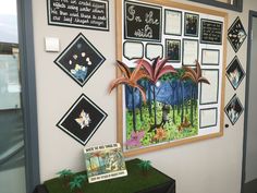 a bulletin board on the wall with pictures and information about trees, plants and animals