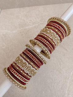 A Large stack of luxurious antique Gold bangles with deep maroon shades and Champagne crystal kada bangles.  Perfect for brides or those wanting to make a statement. Ready to Ship! Antique Gold Bangles, Cristal Champagne, Bridal Survival Kit, Kada Bangles, Bangle Stack, Wedding Bangles, Red Bangles, Bridal Chura, Bangle Box