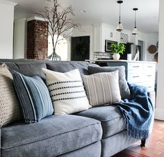 a living room filled with furniture and lots of pillows