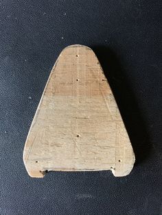 a piece of wood sitting on top of a black surface