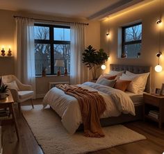 a bedroom with a large bed and lots of windows