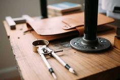 a wooden table topped with lots of tools