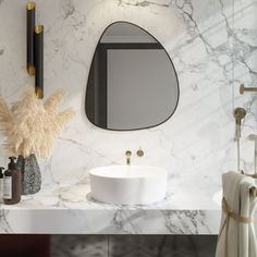 a bathroom with marble counter top and white sink under a round mirror on the wall