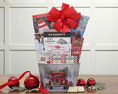 a christmas gift basket with candy, candies and other holiday treats on a table