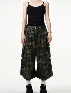 Embrace a fierce combination of style and practicality with our Camo Bermuda Capri Cargo Shorts. These high-waisted shorts feature a classic camouflage print, expertly crafted from a durable blend of materials for lasting comfort. The loose fit promotes freedom of movement while the integrated belt adds a functional, fashionable touch. Pair with a simple tee and sneakers for a laid-back look, or dress them up with a sleek blouse and ankle boots for a more sophisticated angle. Perfect for a varie Summer Combat Cotton Bottoms, Military Style Wide Leg Summer Bottoms, Summer Combat Cargo Bottoms, Summer Combat Cargo Style Bottoms, Combat Cargo Style Bottoms For Summer, Camouflage Wide Leg Cargo Bottoms, Combat Style Bottoms For Summer Streetwear, Military High Waist Bottoms For Streetwear, Utility Streetwear Pants Shorts