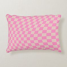 a pink and white checkerboard pattern pillow