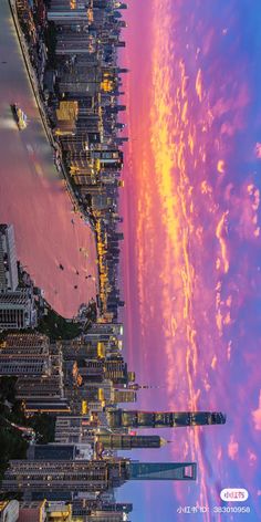 an aerial view of the city skyline at sunset or sunrise, with pink and yellow clouds