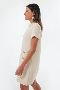 Inspired by the great style icon, Jackie Kennedy, the Pearl White Jackie Dress is crafted from thoughtfully curated details for a timeless closet staple piece. The shift silhouette creates the perfect blank canvas for the textured tweed fabric and luxe braided trim along the neckline and faux front pockets for a look that feels tailored but wears effortlessly. Adorned with gold crest buttons for a vintage touch, this mod mini wears just as well to brunch as it does running the boardroom. Crew ne Classic White Tweed Dress, Tuckernuck Jackie Dress, Chic White Short Sleeve Tweed Dress, Luxury Cream Tweed Dress, Elegant Style, Spring Knee-length Tweed Dress With Button Closure, Jackie Dress, White Tweed, Closet Staples, Jackie O