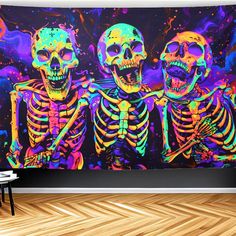 two skeletons in neon colors on a wall