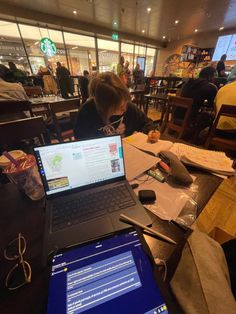 a laptop computer sitting on top of a wooden table