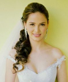 a woman in a wedding dress posing for the camera