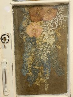 an old door with flowers painted on it