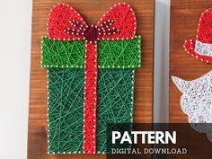 two christmas gifts made out of string sit on top of a wooden board with the words ready - made string art sign