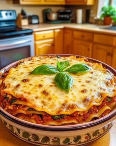 a casserole dish with cheese and basil on top