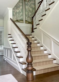 there is a stair case in the hallway with wallpaper on the walls behind it